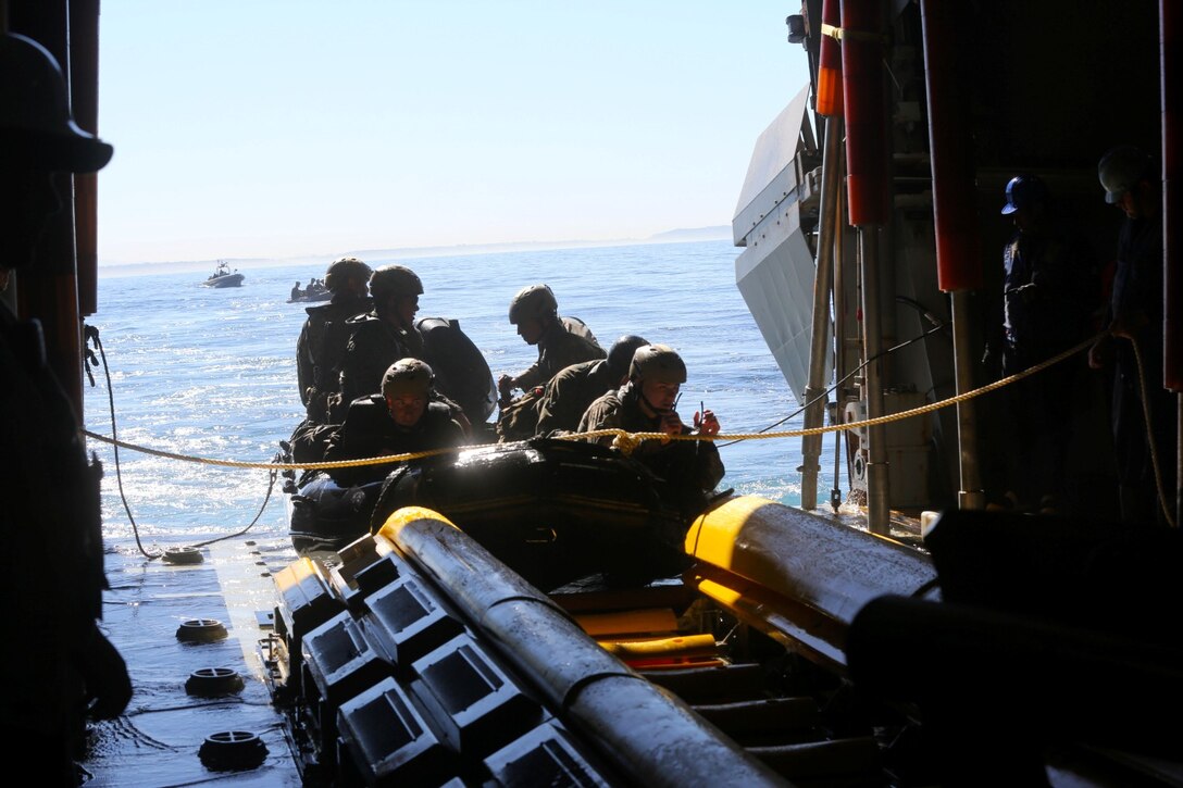 Marines with Bravo Company, 1st Reconnaissance Battalion, prepare to launch a zodiac from the USS Freedom during on and off loading drills three miles off the coast of Del Mar beach Marine Corps Base Camp Pendleton, Calif., March 10, 2014. The Marines conducted a full day of rehearsals prior to the drills because it was their first time training on a littoral combat ship. The LCS gives Marines the opportunity to launch and recover reconnaissance teams from a greater distance out at sea. Gunnery Sgt. Mickey Eaton, assistant operations chief for the company, said the ability to use an LCS is the future for reconnaissance Marines.
