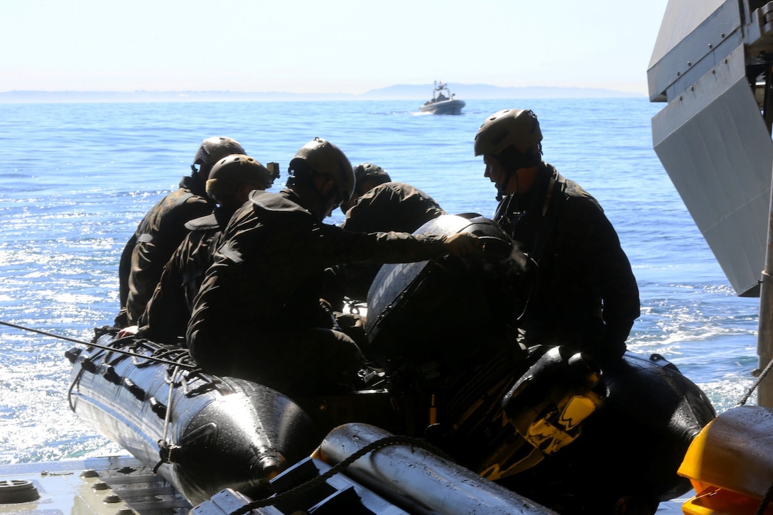 Marines with Bravo Company, 1st Reconnaissance Battalion, prepare to launch a zodiac from the USS Freedom during on and off loading drills three miles off the coast of Del Mar beach Marine Corps Base Camp Pendleton, Calif., March 10, 2014. The purpose of the training was to find out if the Marines could launch and recover a zodiac, a small inflatable boat with a hand steered engine, onto a littoral combat ship. They discovered that using the LCS gave them the ability to insert and recover reconnaissance teams from a greater distance out at sea.