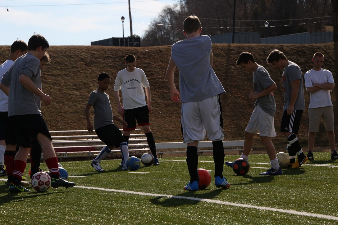 The Quantico Middle/High School boys soccer team practices ball handling skills during practice on March 11, 2014, at Butler Stadium. The team has a few veterans from last season and they hope to help the new faces fall in love with the game. 