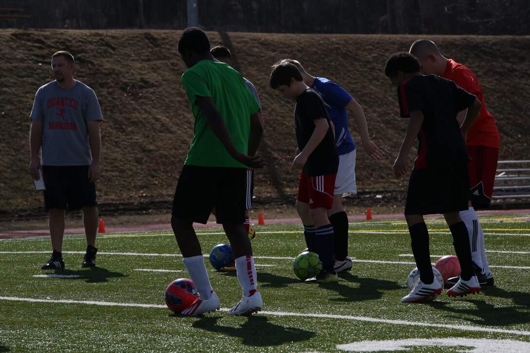 The Quantico Middle/High School boys soccer team practices ball handling skills during practice on March 11, 2014, at Butler Stadium. The team veterans are working to train the new players in the fundamentals while inspiring a love for the game. 