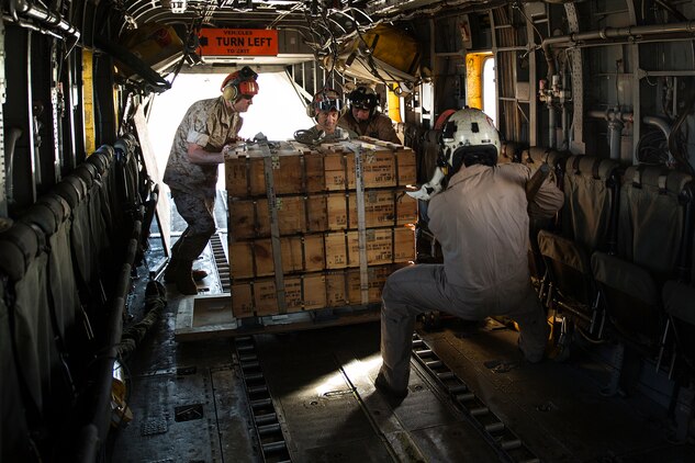 Marines load approximately 8,000 pounds of ammunition supply onto a CH-53E Super Stallion aircraft at Marine Corps Air Station Kaneohe Bay, March 12, 2014. Marine Heavy Helicopter Squadron 463 delivered a total of 15,000 pounds of ammunition through two trips to Marine Light Attack Helicopter Squadron 367 at Bradshaw Airfield on the island of Hawaii in support of Operation Spartan Fury. (U.S. Marine Corps photo by Lance Cpl. Matthew Bragg)