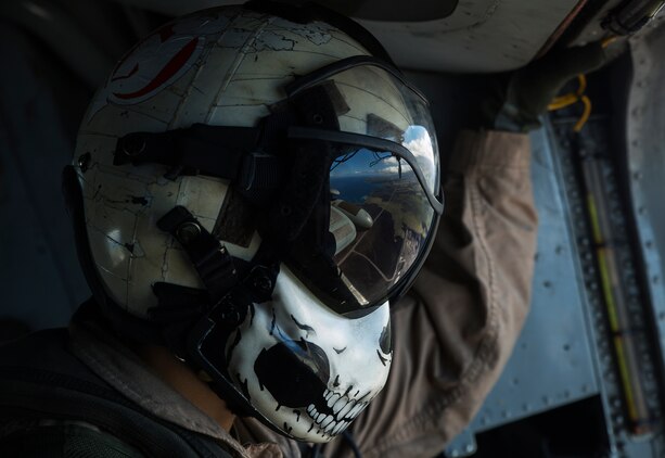 Sgt. Ryan Hetu, a crew chief with Marine Heavy Helicopter Squadron 463 takes in a view of the Island of Hawaii from the window of a CH-53E Super Stallion aircraft after they delivered an ammunition supply to Marine Light Attack Helicopter Squadron 367 at Bradshaw Airfield, March 12, 2014. (U.S. Marine Corps photo by Lance Cpl. Matthew Bragg)