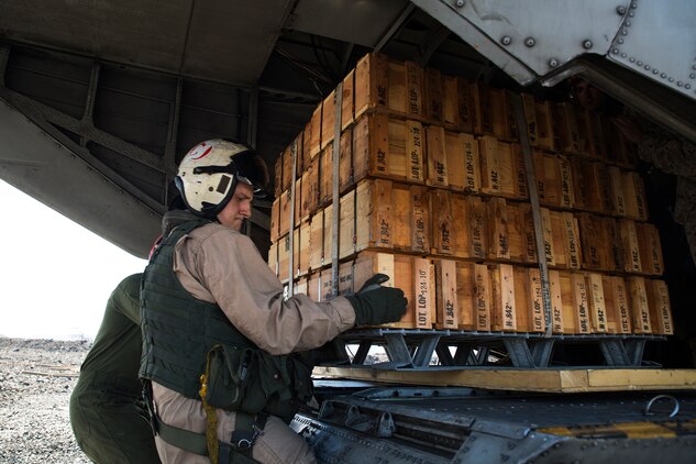 Sgt. Ryan Hetu, a crew chief with Marine Heavy Helicopter Squadron 463, helps unload a pallet of ammunition from a CH-53E aircraft at Bradshaw Airfield on the Island of Hawaii, March 12, 2014. (U.S. Marine Corps photo by Lance Cpl. Matthew Bragg)