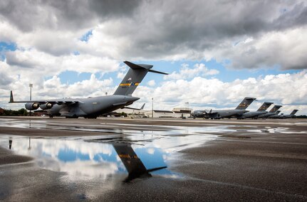 C-17 Globemaster III's assigned to the 437th Airlift Wing sit on the flight line after a rain storm passes over May 7, 2013, at Joint Base Charleston-Air Base, S.C.  (U.S. Air Force photo/Senior Airman Dennis Sloan)
