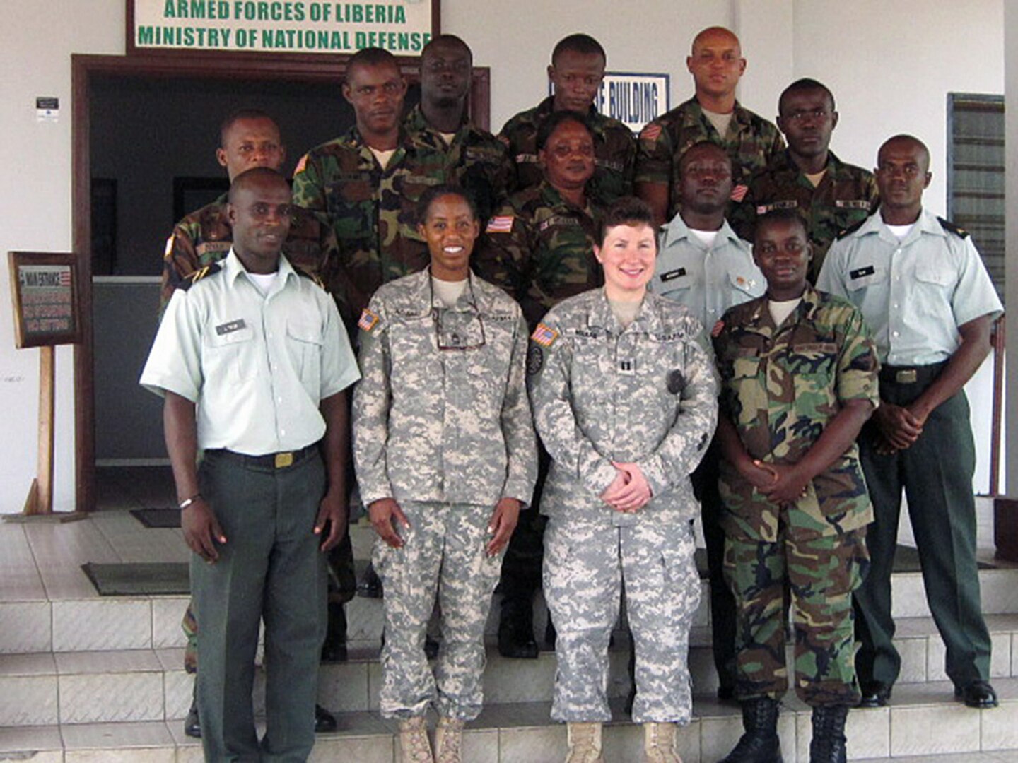 Army Capt. Margaret Mieras and Master Sgt. Angela Adams, both of Michigan, gather with members of the Ministry of Defense and Armed Force of Liberia administrative staff in Monrovia, Liberia on Feb. 20, 2014.