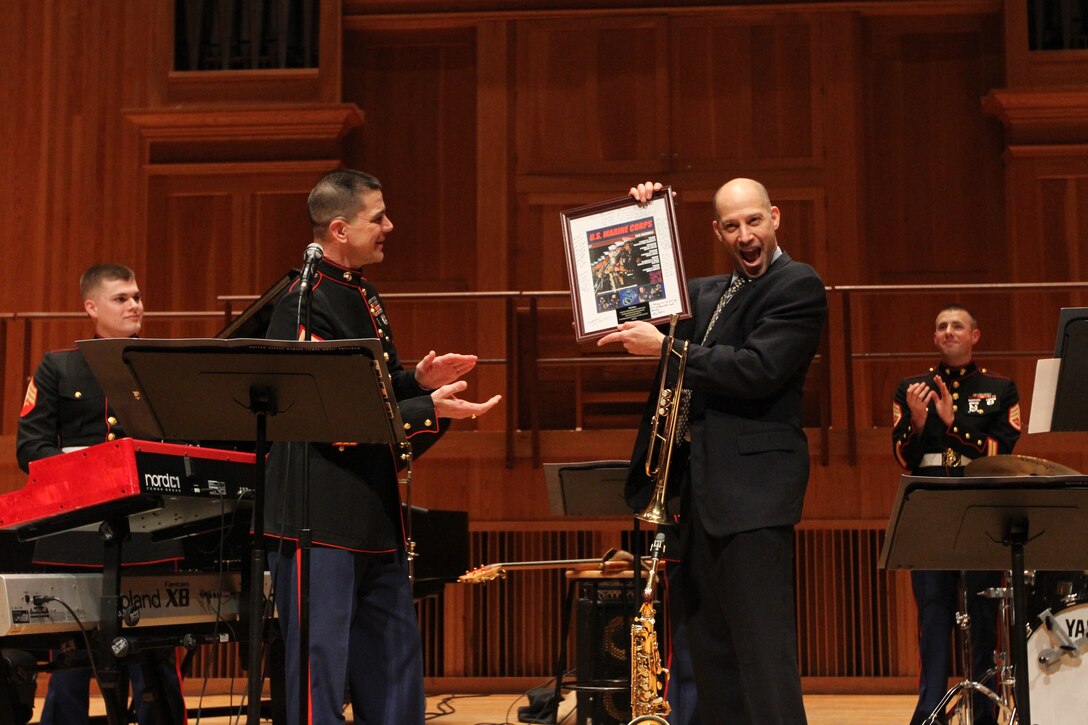 NEW YORK - Michael Mossman, director of music at Queens College, is presented a picture signed by the members of the Marine Corps Jazz Ensemble on March 5 at Queens College’s Aaron Copland School of Music.  The Marine Corps Jazz Ensemble is touring the 1st Marine Corps District’s area of operations to spread knowledge of the Marine Corps’ Musician Enlistment Option Program.  (U.S. Marine Corps photo by Lance Cpl. Brandon Thomas).