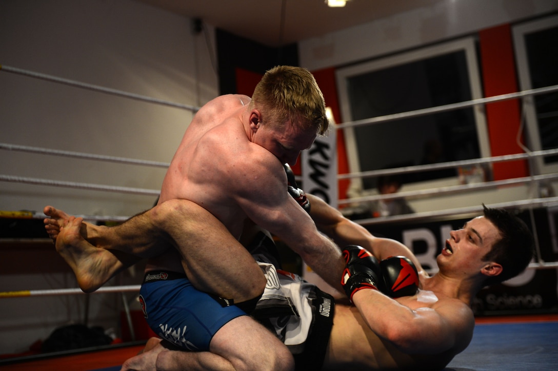 U.S. Air Force Senior Airman Sean Whitaker, a Spangdahlem mixed martial arts member from Pittsburgh, fights for position over his opponent during his match at an MMA tournament in Pruem, Germany, March 8, 2014. Fighters have approximately six weeks notice before fighting in an event; Whitaker had only 12 days to prepare due to last-minute changes in the lineup. (U.S. Air Force photo/Senior Airman Gustavo Castillo)