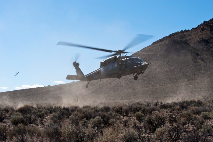 A U.S. Air Force HH-60G Pave Hawk assigned to the 66th Rescue Squadron, Nellis Air Force Base, Nev. lands at an extraction point while participating in a combat search and rescue exercise during Red Flag 14-2 March 11, 2014, on the Nevada Test and Training Range. Red Flag provides combat training in a degraded and operationally limited environment making the training missions as realistic as possible with-out actually being in combat. Practicing search and rescue operations in a training environment will improve efficiency and readiness for future real-world operations. (U.S. Air Force photo by Airman 1st Class Thomas Spangler)