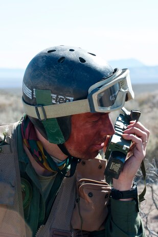 Senior Captain Beguin “Jeff” Jean-Francois, a pilot with the Belgian air force, communicates with a rescue aircraft while participating in a combat search and rescue exercise during Red Flag 14-2 March 11, 2014 on the Nevada Test and Training Range. Jean-Francois was acting as a pilot that had been shot down in enemy territory who must evade the enemy and reach an extraction point. Red Flag gives service members from various airframes, military services and allied nations the opportunity to work together in a realistic training environment. (U.S. Air Force photo by Airman 1st Class Thomas Spangler)  