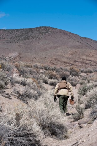 Senior Captain Beguin “Jeff” Jean-Francois, Belgian air force pilot, moves along a ditch while participating in a combat search and rescue exercise during Red Flag 14-2 March 11, 2014, on the Nevada Test and Training Range. Jean-Francois is acting as a shot down pilot in enemy territory that must reach an extraction point while avoiding contact with individuals acting as the enemy. (U.S. Air Force photo by Airman 1st Class Thomas Spangler) 