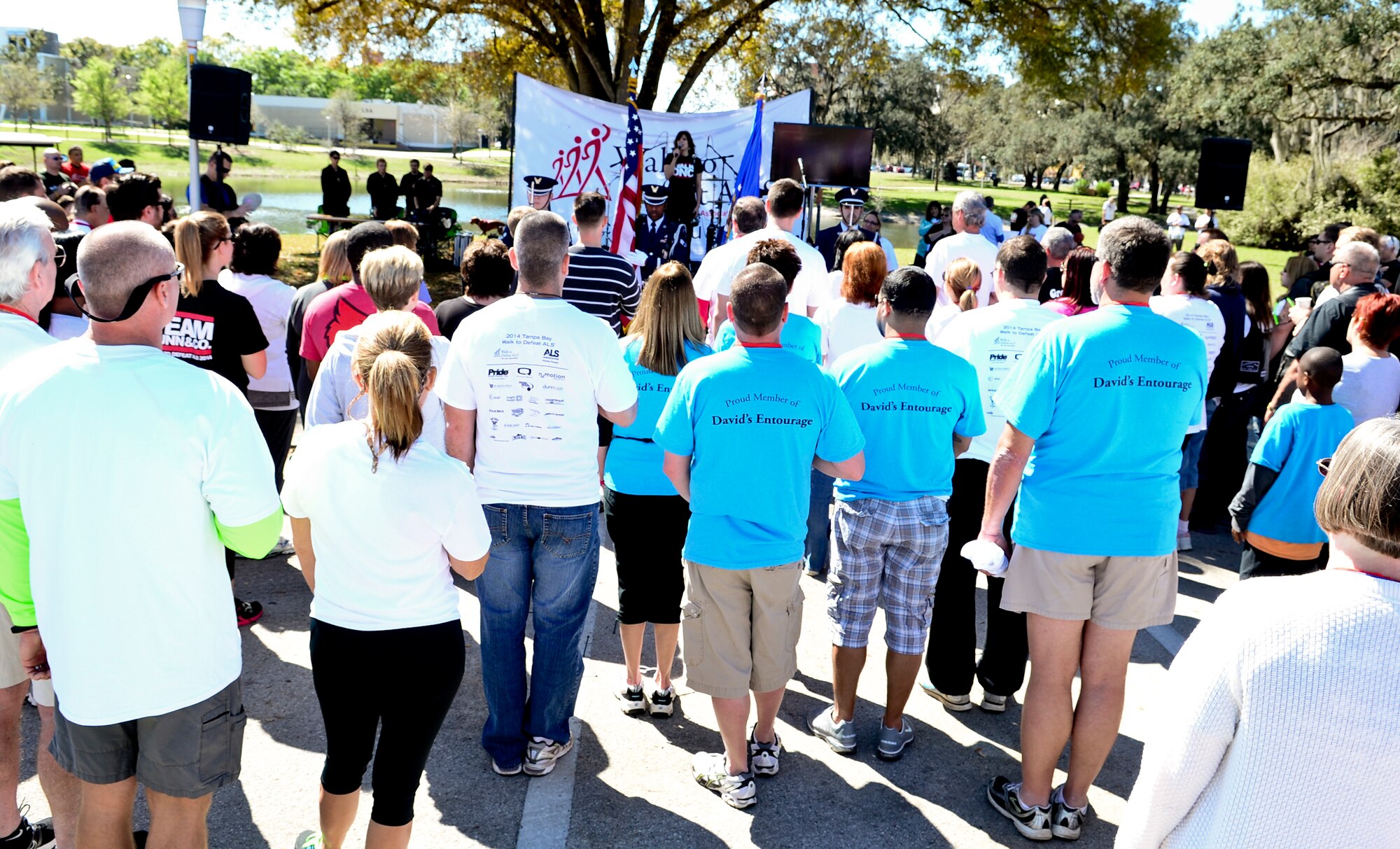 Supporters from the local community show their respect during the singing of the National Anthem before the Walk to Defeat Amyotrophic Lateral Sclerosis event at the University of South Florida, March 8, 2014. The event raised over 190,000 dollars toward sustaining care services and supporting research for ALS. (U.S. Air Force photo by Senior Airman Melanie Bulow-Gonterman/Released) 
