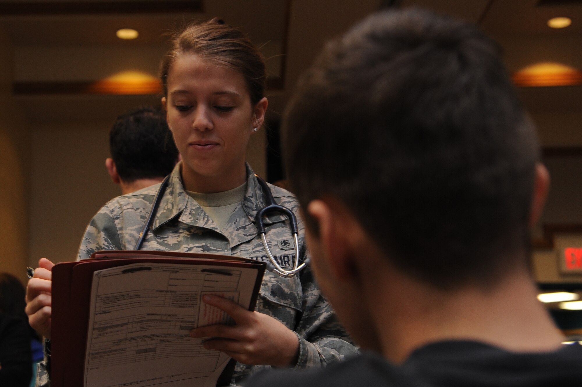 ALTUS AIR FORCE BASE, Okla. – U.S. Air Force Airman 1st Class Maci Clark, 97th Medical Operations Squadron medical technician, speaks to a patient during a severe weather exercise in the Freedom Community Center March 12, 2014. Medical technicians ask their patient questions to assist them in receiving proper medical care. (U.S. Air Force photo by Airman 1st Class J. Zuriel Lee/Released)