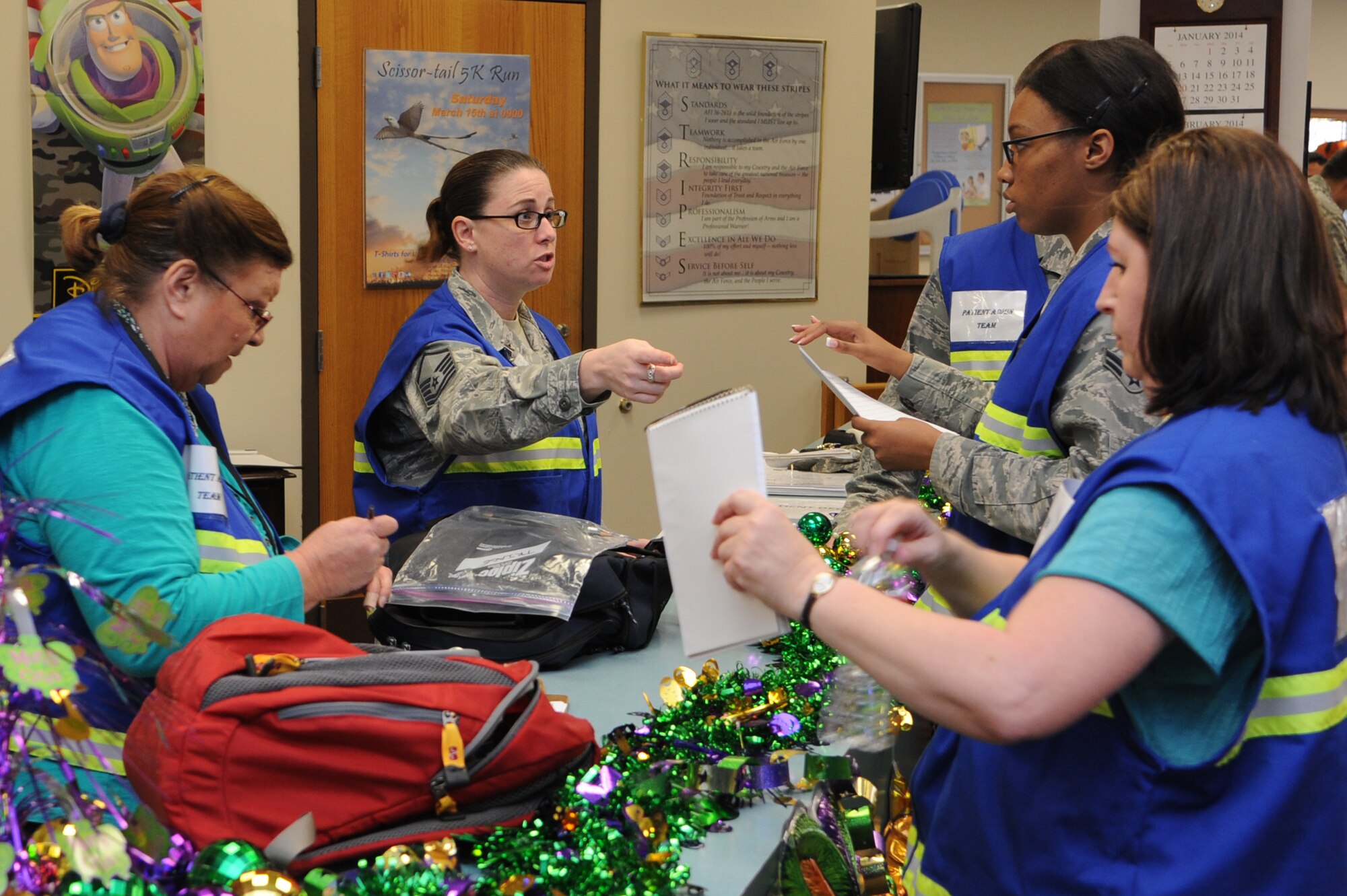 ALTUS AIR FORCE BASE, Okla. – U.S. Air Force Master Sgt. Michelle Wilkerson, 97th Medical Support Squadron patient admin team chief, directs her team during a severe weather exercise in the Freedom Community Center March 12, 2014. She advised them on handling patients quickly to ensure their medical needs are met. (U.S. Air Force photo by Airman 1st Class J. Zuriel Lee/Released)
