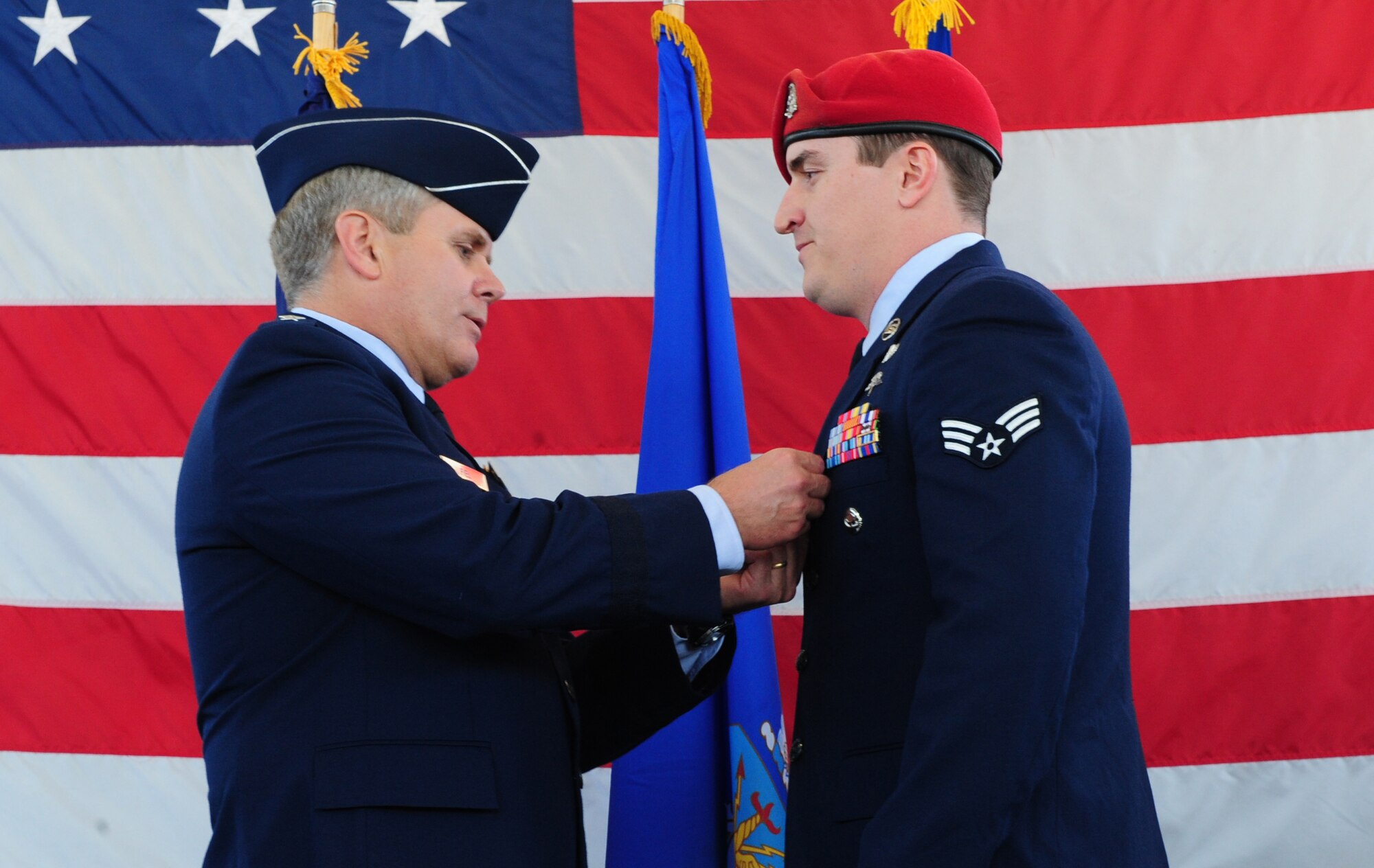 Lt. Gen. Eric Fiel, Air Force Special Operations Command commander, pins the Air Force Combat Action Medal on Senior Airman Nathan Wright at the 23rd Special Tactics Squadron, Hurlburt Field, Fla., March 14, 2014. Airman Wright earned the medal for being physically engaged in combat and taking enemy fire on a mission while deployed. (U.S. Air Force photo/Staff Sgt. Victoria Sneed)