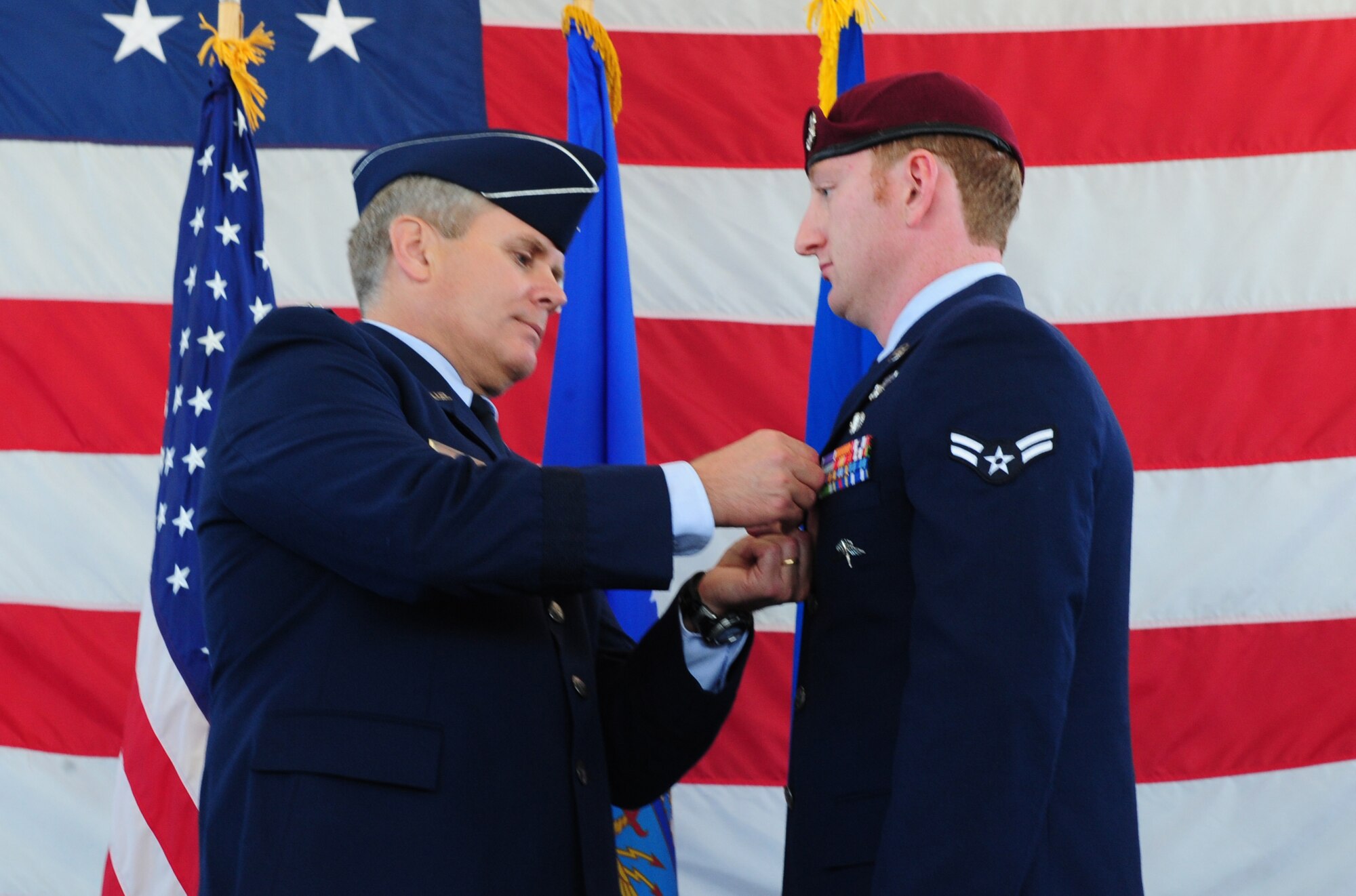 Lt. Gen. Eric Fiel, Air Force Special Operations Command commander, pins a purple heart on Airman First Class Phillip Armstrong at the 23rd Special Tactics Squadron, Hurlburt Field, Fla., March 14, 2014. Airman Armstrong received the purple heart for wounds received in combat.  (U.S. Air Force photo/Staff Sgt. Victoria Sneed)