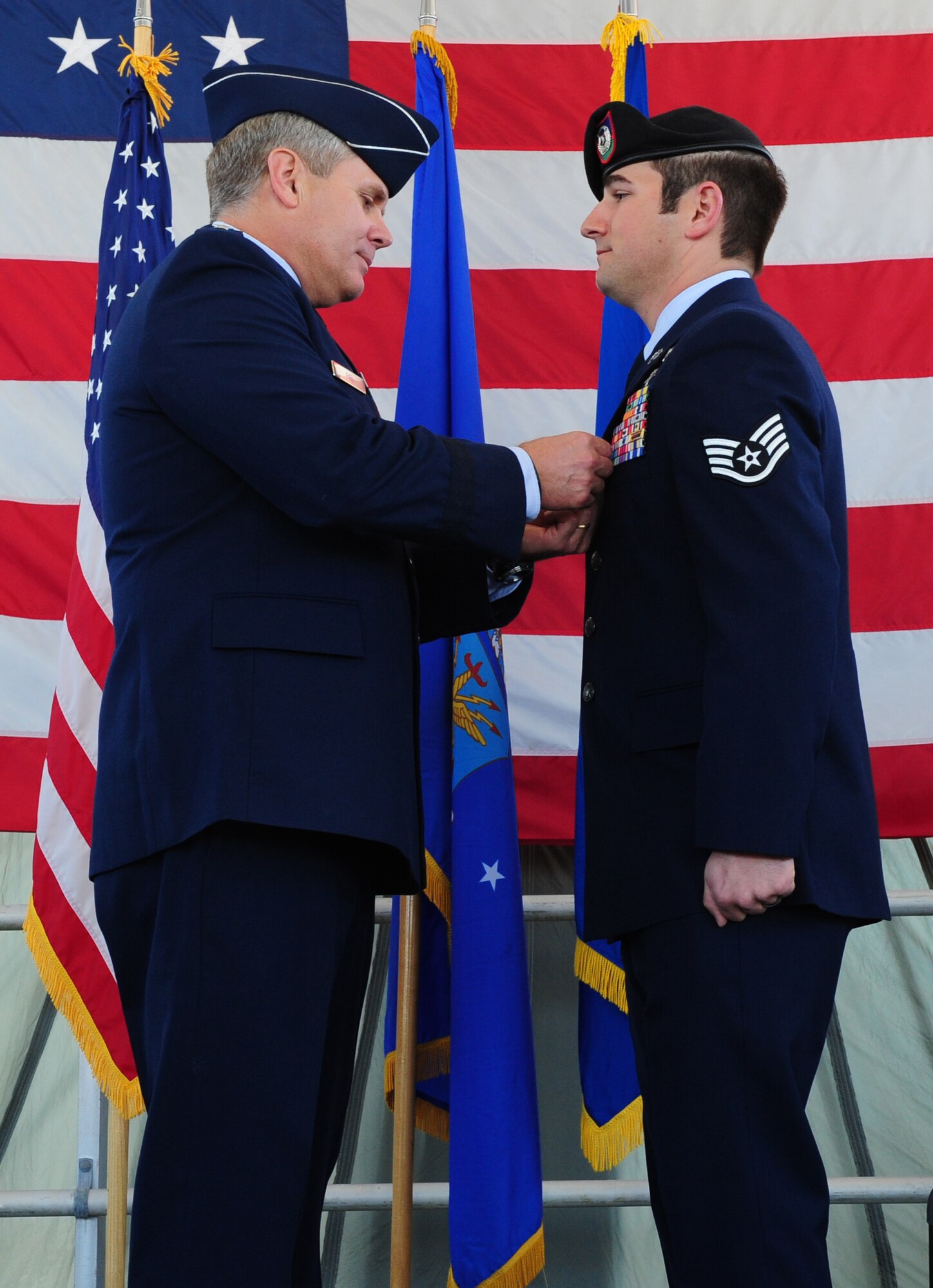 Lt. Gen. Eric Fiel, Air Force Special Operations Command commander, pins a Bronze Star on Staff Sgt. Stephen Merlics at the 23rd Special Tactics Squadron, Hurlburt Field, Fla., March 14, 2014. Sgt. Merlics distinguished himself by coordinating medical evacuation while taking enemy fire on a mission while deployed in Afghanistan. (U.S. Air Force photo/Staff Sgt. Victoria Sneed)