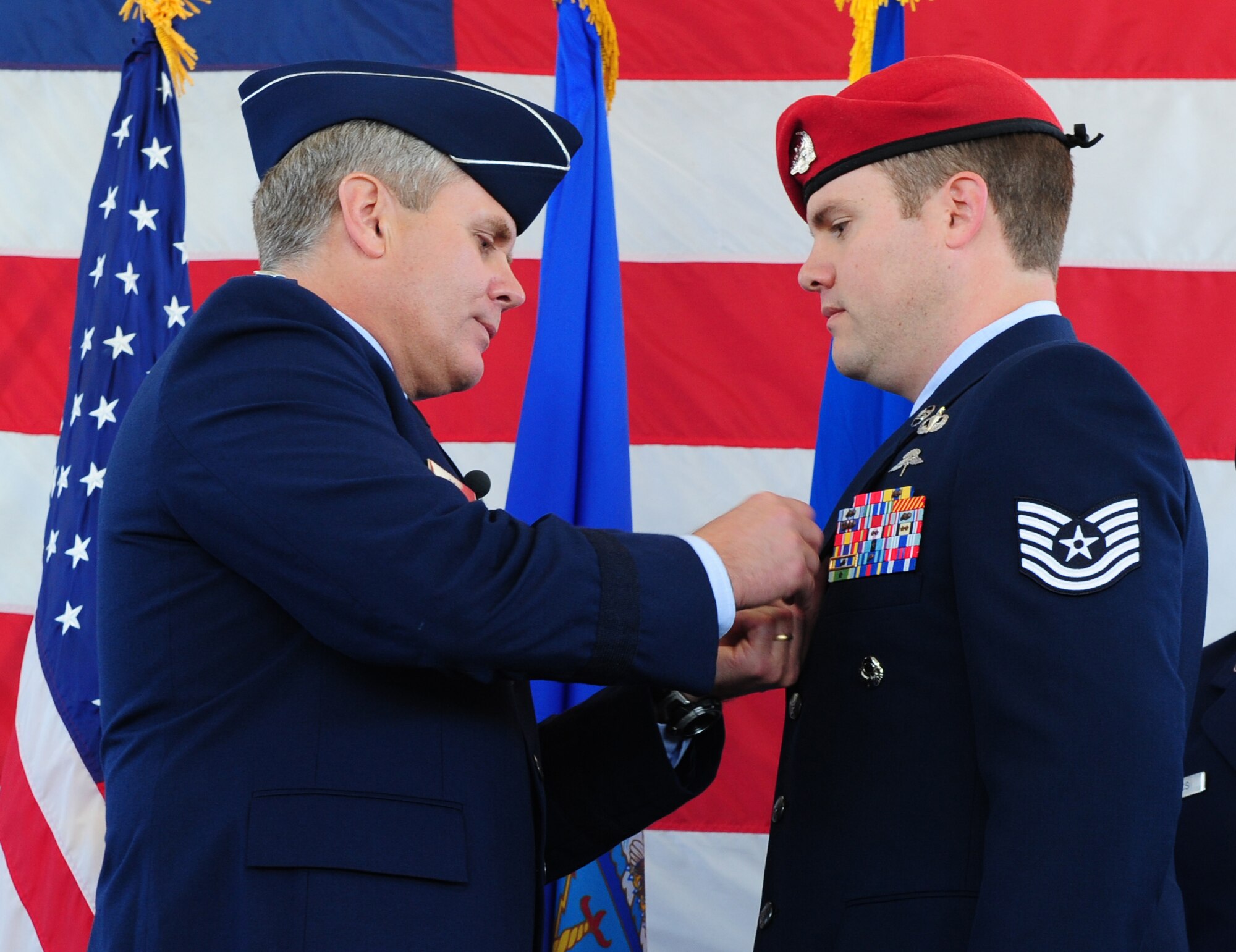 Lt. Gen. Eric Fiel, Air Force Special Operations Command commander, pins a Silver Star medal on the lapel of Tech. Sgt. Michael Blout at the 23rd Special Tatics Squadron, Hurlburt Field, Fla., March 14, 2014. Blout distinguished himself by using his own body as a shield for a wounded team member as he called in air support on a deployment in Afghanistan. (U.S. Air Force photo/Staff Sgt. Victoria Sneed)