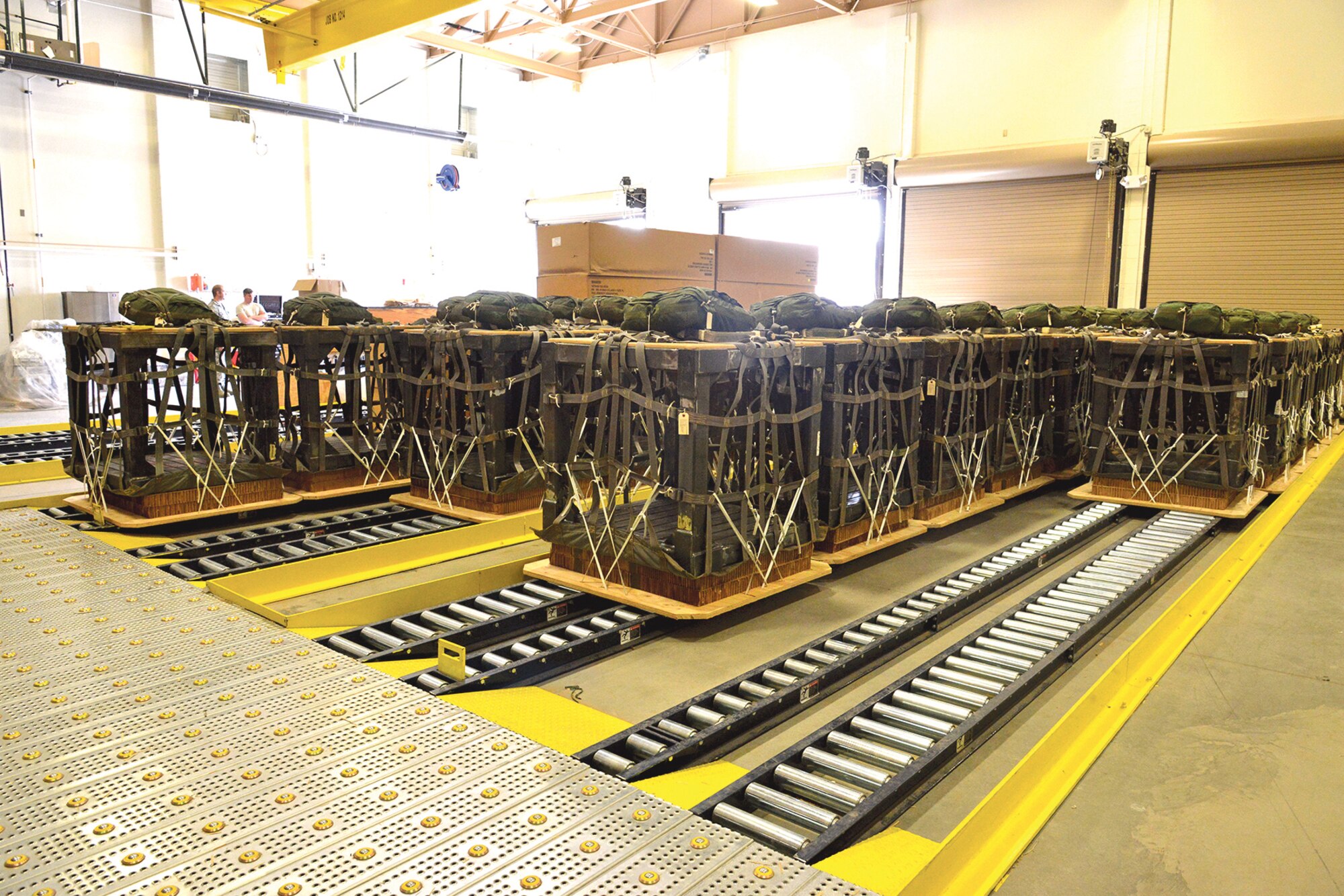 "High-speed” packages, prepared by the crew at the 58th Operations Support Squadron at Kirtland, can be dropped without slowing the aircraft. The parachutes are smaller, so they land at a higher velocity. (Photo by Ken Moore)