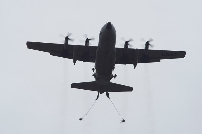 U.S. Army paratroopers jump from a Lockheed C-130 Hercules Dec. 7, 2013, in support of Operation Toy Drop at Fort Bragg, N.C. The 16th Annual Randy Oler Operation Toy Drop, hosted by the U.S. Army Civil Affairs & Psychological Operations Command (Airborne), is the largest combined airborne operation in the world. Fort Bragg’s paratroopers and allied jumpmasters donate toys to be distributed to children’s homes and social service agencies across the local community. (U.S. Air Force photo/Senior Airman Logan Brandt)
