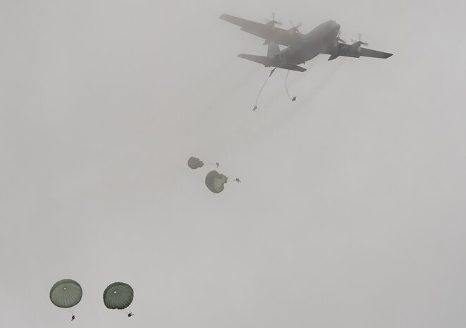 U.S. Army paratroopers float to the ground Dec. 7, 2013, after successfully jumping from a Lockheed C-130 Hercules in support of Operation Toy Drop at Fort Bragg, N.C., The 16th Annual Randy Oler Operation Toy Drop, hosted by the U.S. Army Civil Affairs & Psychological Operations Command (Airborne), is the largest combined airborne operation in the world. Fort Bragg’s paratroopers and allied jumpmasters donate toys to be distributed to children’s homes and social service agencies across the local community. (U.S. Air Force photo/Senior Airman Logan Brandt)