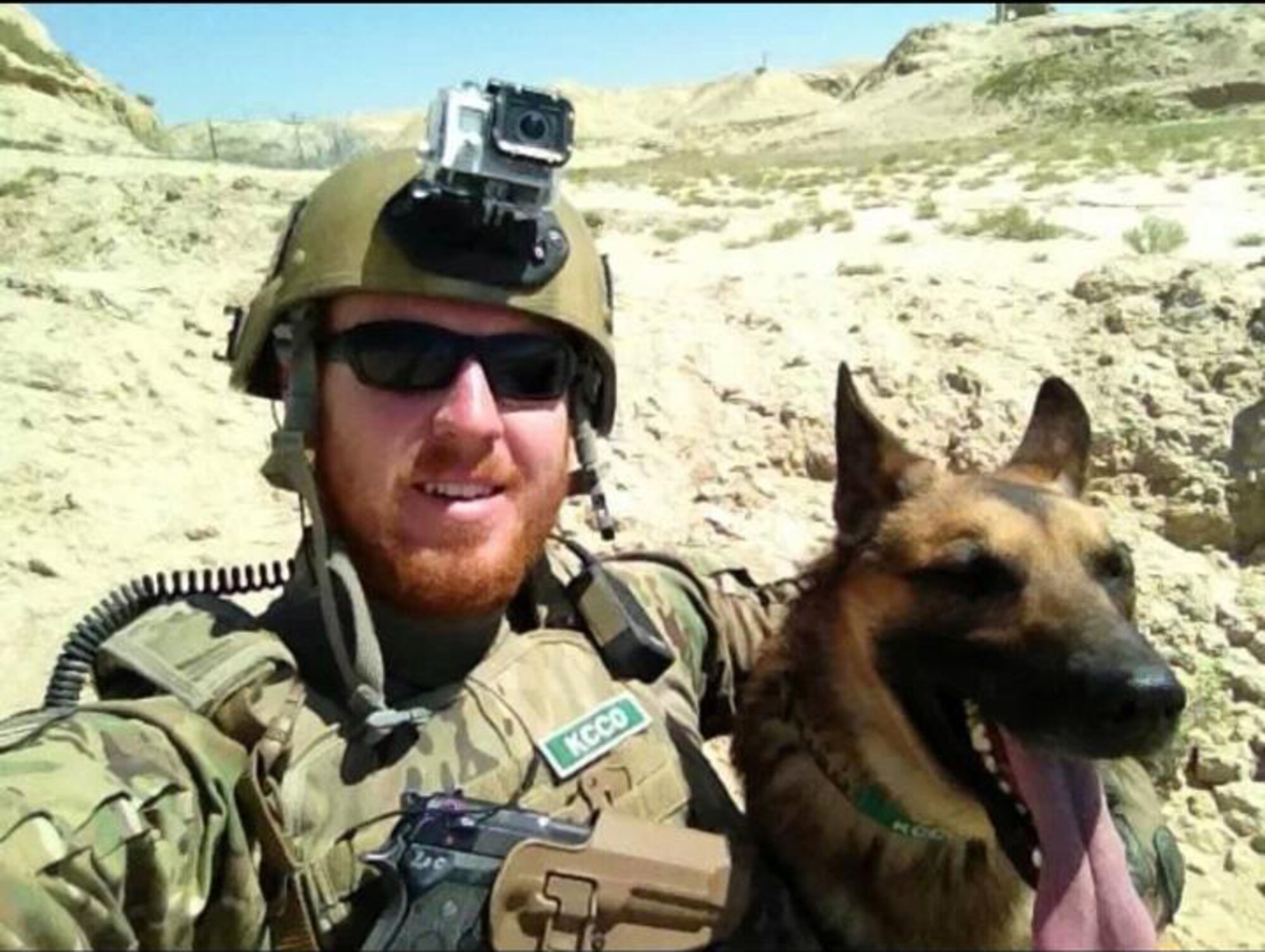 U.S. Air Force Senior Airman Brandon Johnson, 822nd Base Defense Squadron Military Working Dog handler, and MWD Diyi from Moody Air Force Base, Ga., take a photo while deployed to Afghanistan May 2013. During a deployment in 2012, Johnson and Diyi were assigned to the 7th Special Forces Group out of Eglin AFB, Fla. at a village stability platform where they worked with Army special forces and lived with the local villagers. This deployment resulted in Diyi developing canine post traumatic stress disorder. (Courtesy photo) 