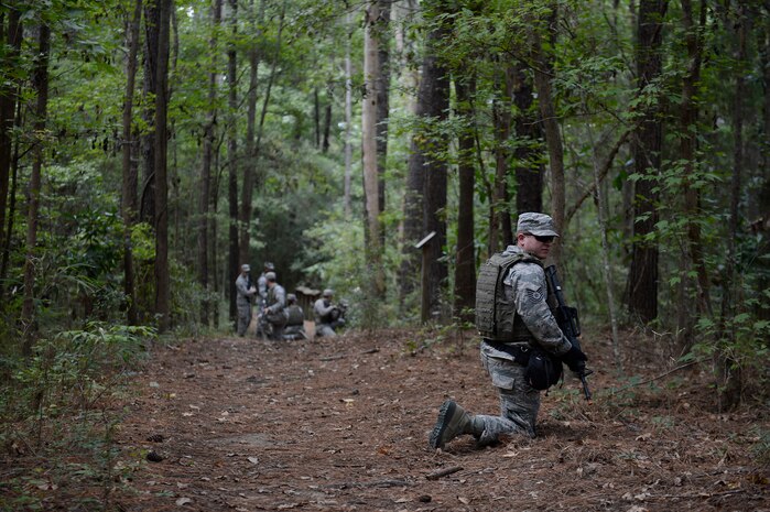 U.S. Air Force Tech Sgt. Barry Loo, combat photojournalist, 1st Combat Camera Squadron, pulls security for his team Oct. 3, 2013, at Joint Base Charleston - Weapons Station, S.C. Squadron personnel conducted the training to enhance unit photography and tactical skills to ensure mission readiness. (U.S. Air Force photo/Senior Airman Logan Brandt)