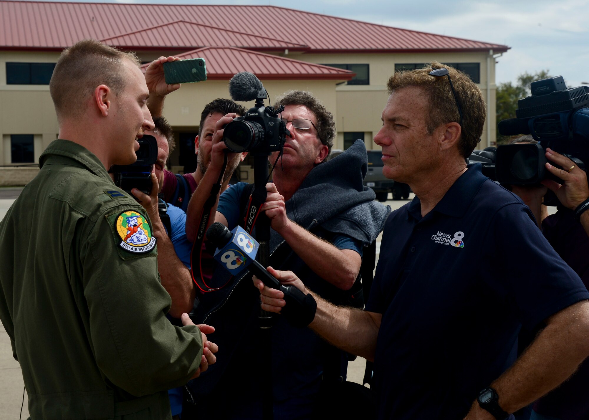 Media from the city of Tampa, Fla. interview the co-pilot from the media operations flight after landing March 12, 2014 at MacDill Air Force Base, Fla.  Media personnel captured and documented the mission through photographs, video and interviews. (U.S. Air Force photo by Senior Airman Jenay Randolph/Released)