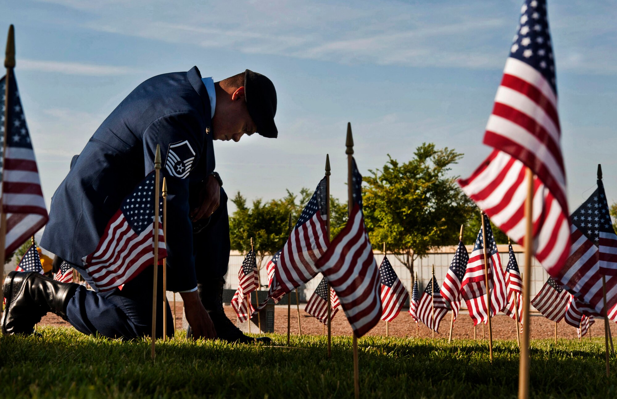 U.S. Air Force Master Sgt. Robert Lilly, 57th Operations Group joint tactical air controller, pays his respects to a fallen veteran May 28, 2013, at the Southern Nevada Veterans Memorial Cemetery, Boulder City, Nev. Lilly and other Airmen from Nellis Air Force Base, Nev., volunteered their time to place flags on veterans’ cemetery plots for Memorial Day weekend. (U.S. Air Force photo/Senior Airman Daniel Hughes)