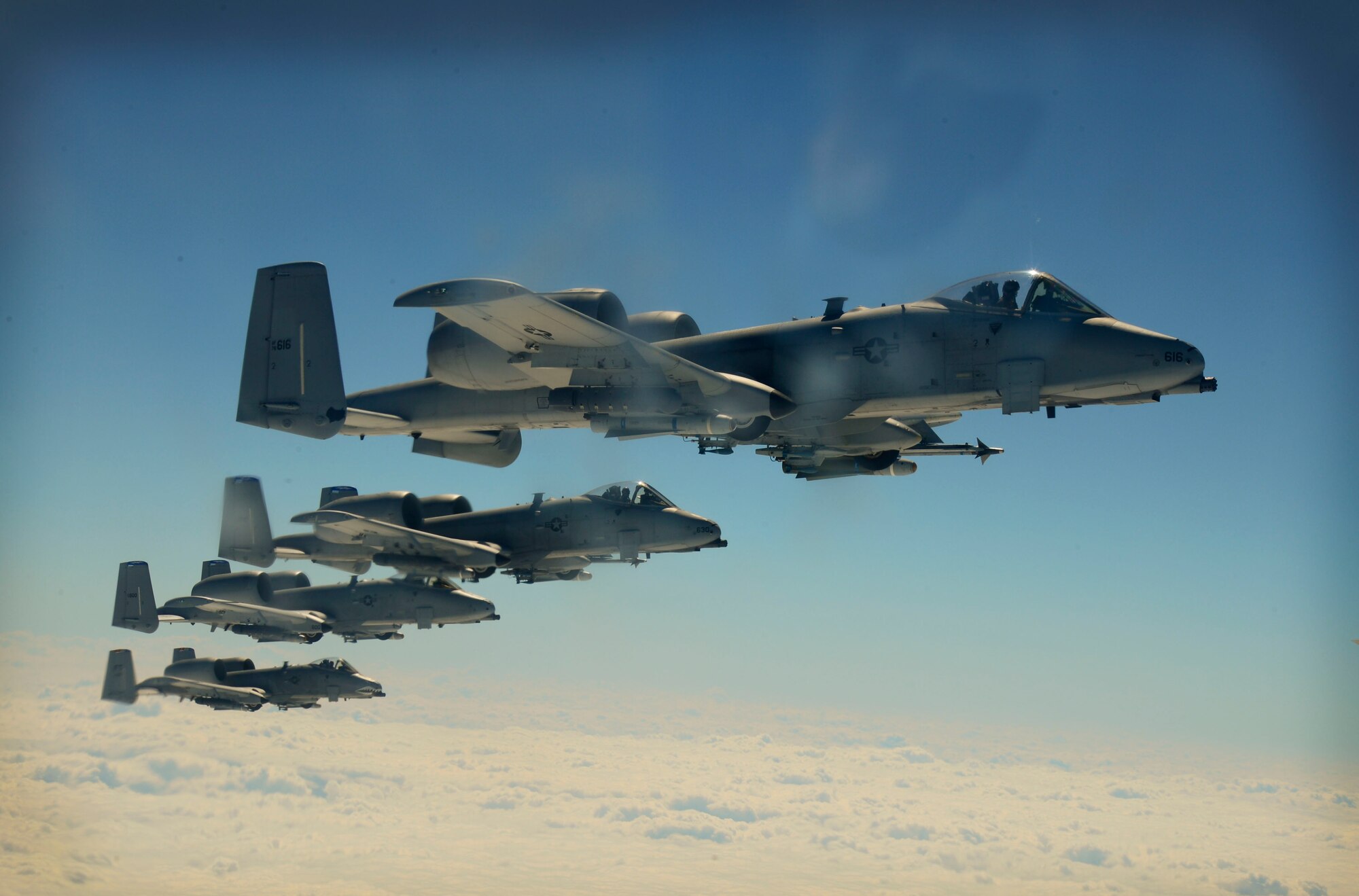 Four A-10 Thunderbolts fly alongside a KC-135 Stratotanker March 12, 2014 over Moody Air Force Base, Ga. The flight was approximately four hours long and allowed the crew to hone their skills and allow the media to experience one of the many missions of the Air Force.  (U.S. Air Force photo by Senior Airman Jenay Randolph/Released)
