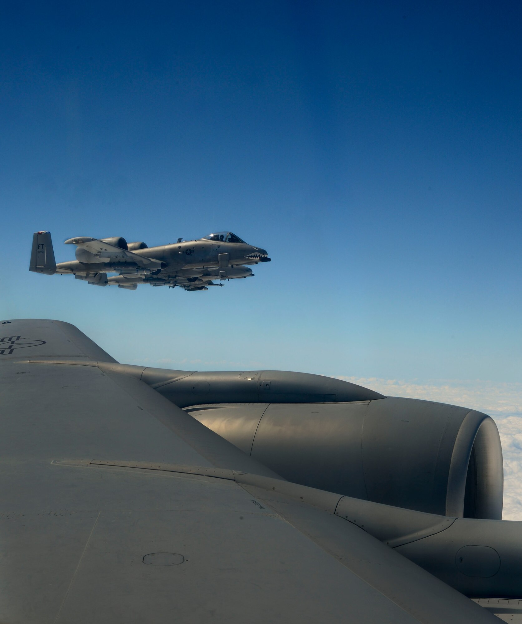 Three A-10 Thunderbolts fly alongside a KC-135 Stratotanker during a media operations flight March 12, 2014 from MacDill Air Force Base, Fla. The flight was approximately four hours long and allowed the crew to hone their skills and allow the media to experience one of the many missions of the Air Force.  (U.S. Air Force photo by Senior Airman Jenay Randolph/Released)
