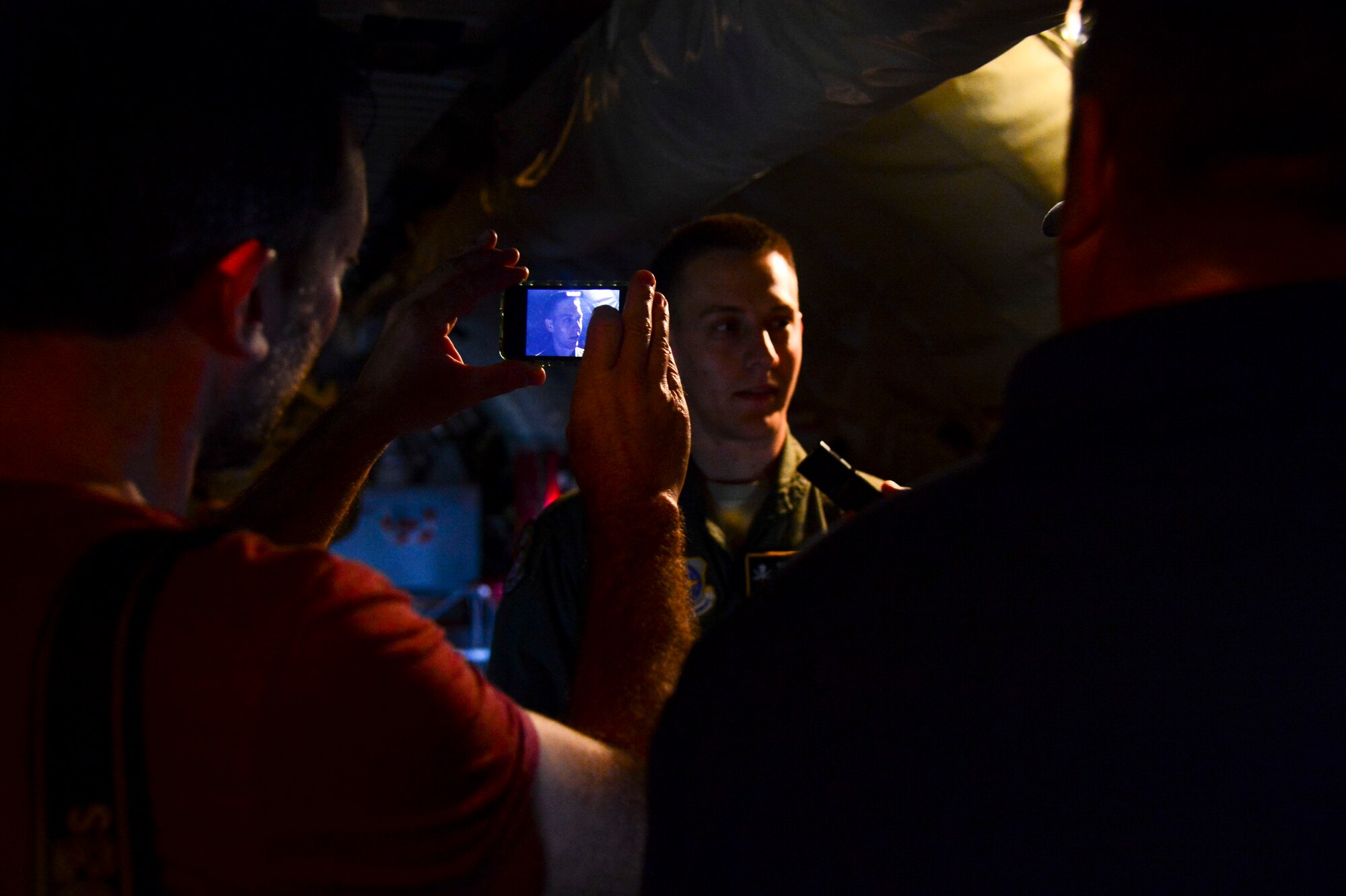 Media from the city of Tampa, Fla. record Senior Airman Darren Clever, 91st Air Refueling Squadron boom operator, interview during a media operations flight March 12, 2014 at MacDill Air Force Base, Fla. Roughly 15 media personnel captured and documented the mission through photographs, video and interviews. (U.S. Air Force photo by Senior Airman Jenay Randolph/Released)