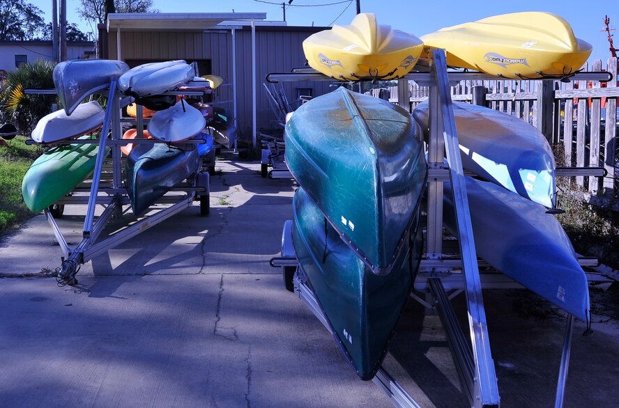 Kayaks and canoes of various colors at sit on trailers March 13 at Bonita Bay Outdoor Recreation. Bonita Bay offers a selection of aquatic transportation for rent to Airmen in the local area. (U.S. Air Force photo by Airman 1st Class Solomon Cook)   