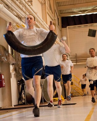 Airmen from the 133rd Airlift Wing’s Communication Flight, Maintenance Group and Public Affairs Office came together for some additional camaraderie and physical training during their busy drill weekend, here in the north hangar, Feb. 23, 2014. (U.S. Air National Guard photo by Staff Sgt. Austen Adriaens/Released)