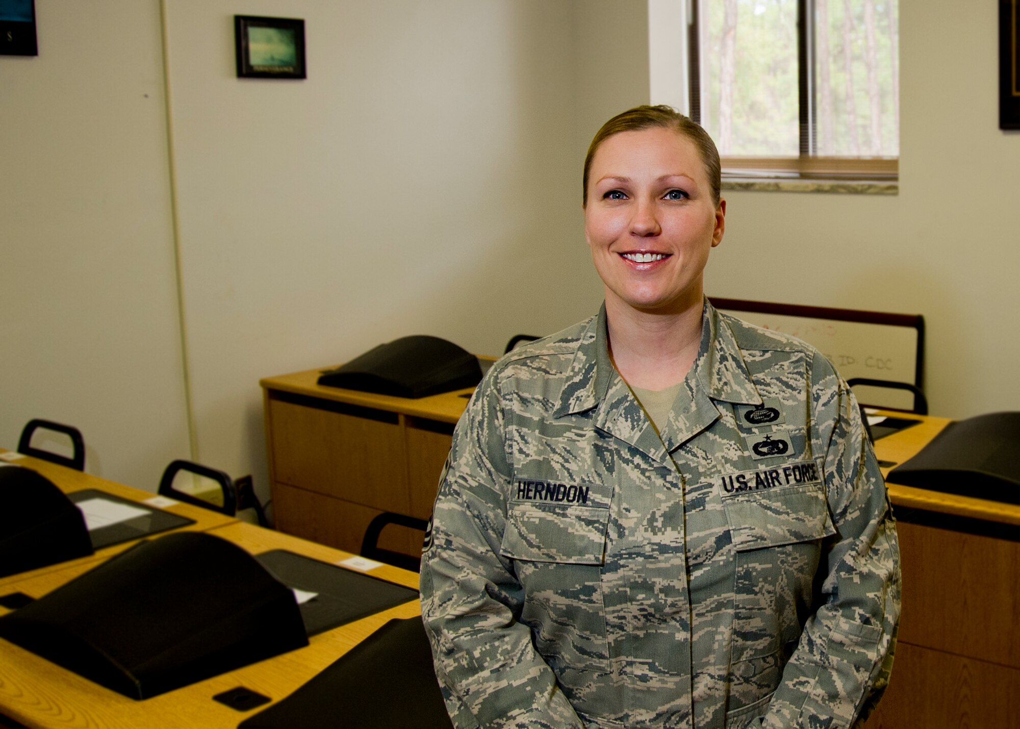 Master Sgt. Kelly Herndon, 325th Force Support Squadron base training superintendent, poses for a portrait March 6 at the base education building. Herndon helped coordinate with several career field managers, fixing errors which ultimately influenced approximately 26,000 careers, helping win her the 2013 Headquarters 9th Air Force Senior NCO of the year award. (U.S. Air Force photo by Airman 1st Class Dustin Mullen)