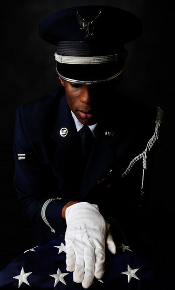 Airman 1st Class Vernon L. Fowler Jr., 6th Air Mobility Wing honor guardsman, presents the flag at MacDill Air Force Base, Fla., March 14, 2014. The base honor guard prides itself in showing the utmost dignity and respect in all the services it provides. (U.S. Air Force photo illustration by Senior Airman Shandresha Mitchell/ Released)