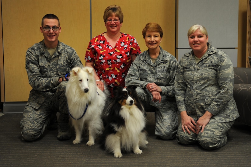 Members of U.S. Air Force Hospital Langley pose with American Red Cross certified therapy dogs, Lothair and Molly, at Langley Air Force Base, Va., Feb. 14, 2014. To become a registered therapy dog, canines are trained and evaluated on 12 areas such as obedience, personality and socialization skills. (U.S. Air Force photo by Senior Airman Brittany Paerschke-O’Brien/Released)