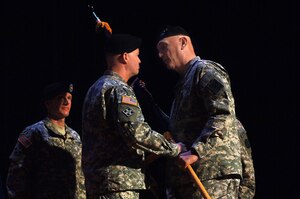 U.S. Army Gen. David Perkins, left, U.S. Army Training and Doctrine Command incoming commander, accepts the unit colors from Gen. Raymond Odierno, right, U.S. Army chief of staff, during a change of command ceremony at Fort Eustis, Va., March 14, 2014. Perkins assumed command of TRADOC from Gen. Robert Cone. Perkins hails from N.H., and Odierno is a native of Rockaway, N.J. (U.S. Air Force photo by Senior Airman Teresa J.C. Aber/Released)