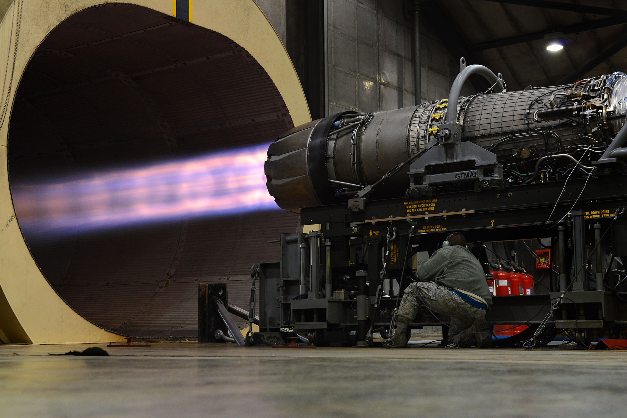 U.S. Air Force Staff Sgt. Daniel Gallentine, 20th Component Maintenance Squadron jet engine craftsman, inspects a jet engine at the engine test facility, Shaw Air Force Base, S.C., March 13, 2014. While the engine was at 29,000 pounds thrust capacity, Gallentine checked for oil and air leaks as well as any vibrating parts to ensure all components were working properly. (U.S. Air Force photo by Airman 1st Class Jensen Stidham/Released)