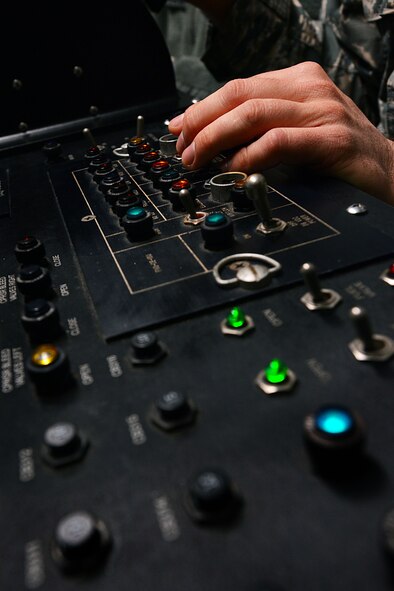 A 20th Component Maintenance Squadron jet engine craftsman, prepares a control board inside a control booth at the engine test facility, Shaw Air Force Base, S.C., March 13, 2014. The throttle controls the amount of jet fuel, contained in two 2,500 gallon fuel tanks, that enters the F110-General Electric-129 jet engine during testing. (U.S. Air Force photo by Airman 1st Class Jensen Stidham/Released)