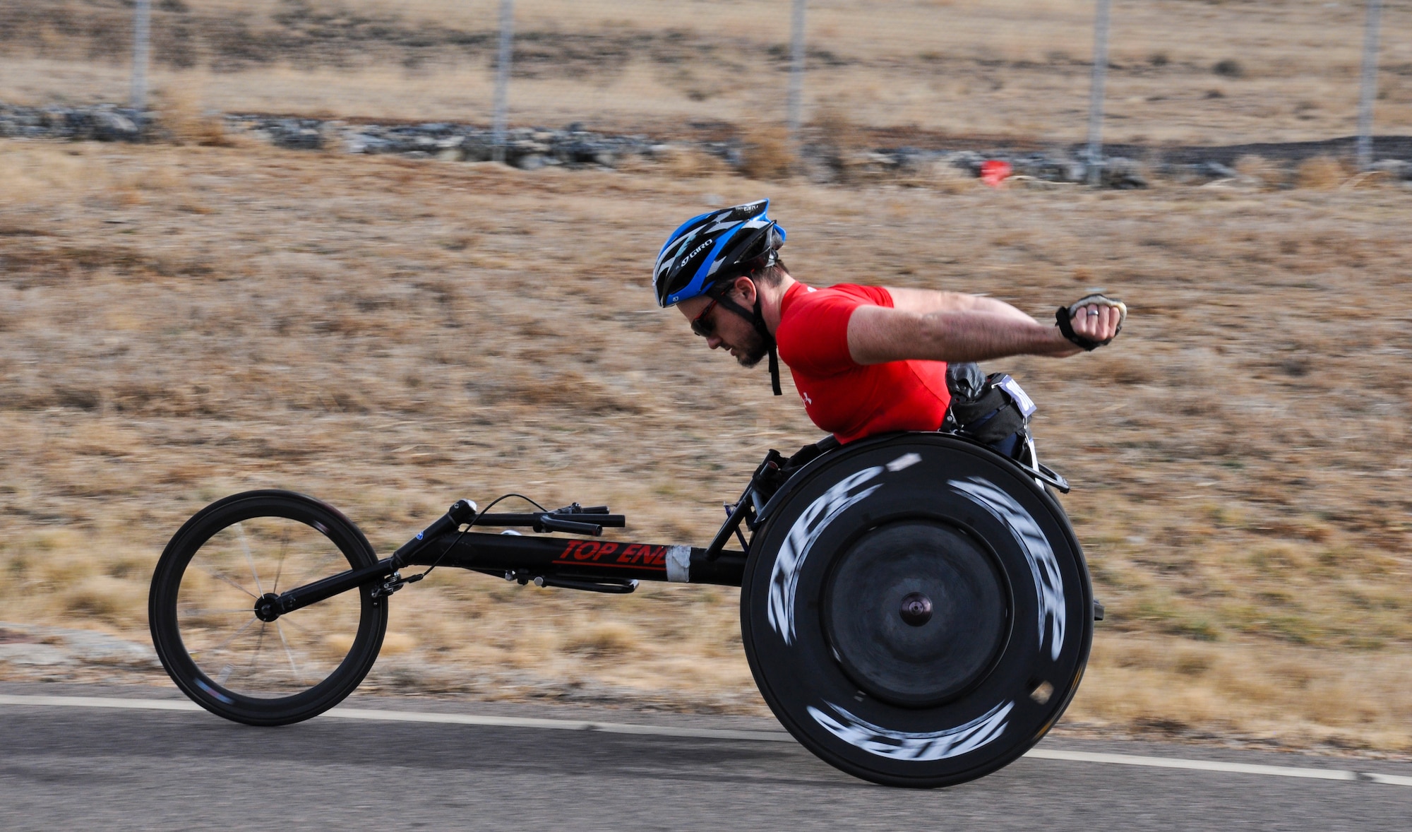 Tyler Byers, Team Buckley civilian Airman and two-time Paralympic Games competitor, keeps his body in top-notch racing shape by training on the base roads Dec. 18, 2014, at Buckley Air Force Base, Colo. Byers competed in the 2004 Paralympic Games in Athens and the 2008 Paralympic Games in Beijing. (U.S. Air Force photo by Staff Sgt. Nicholas Rau/Released) 