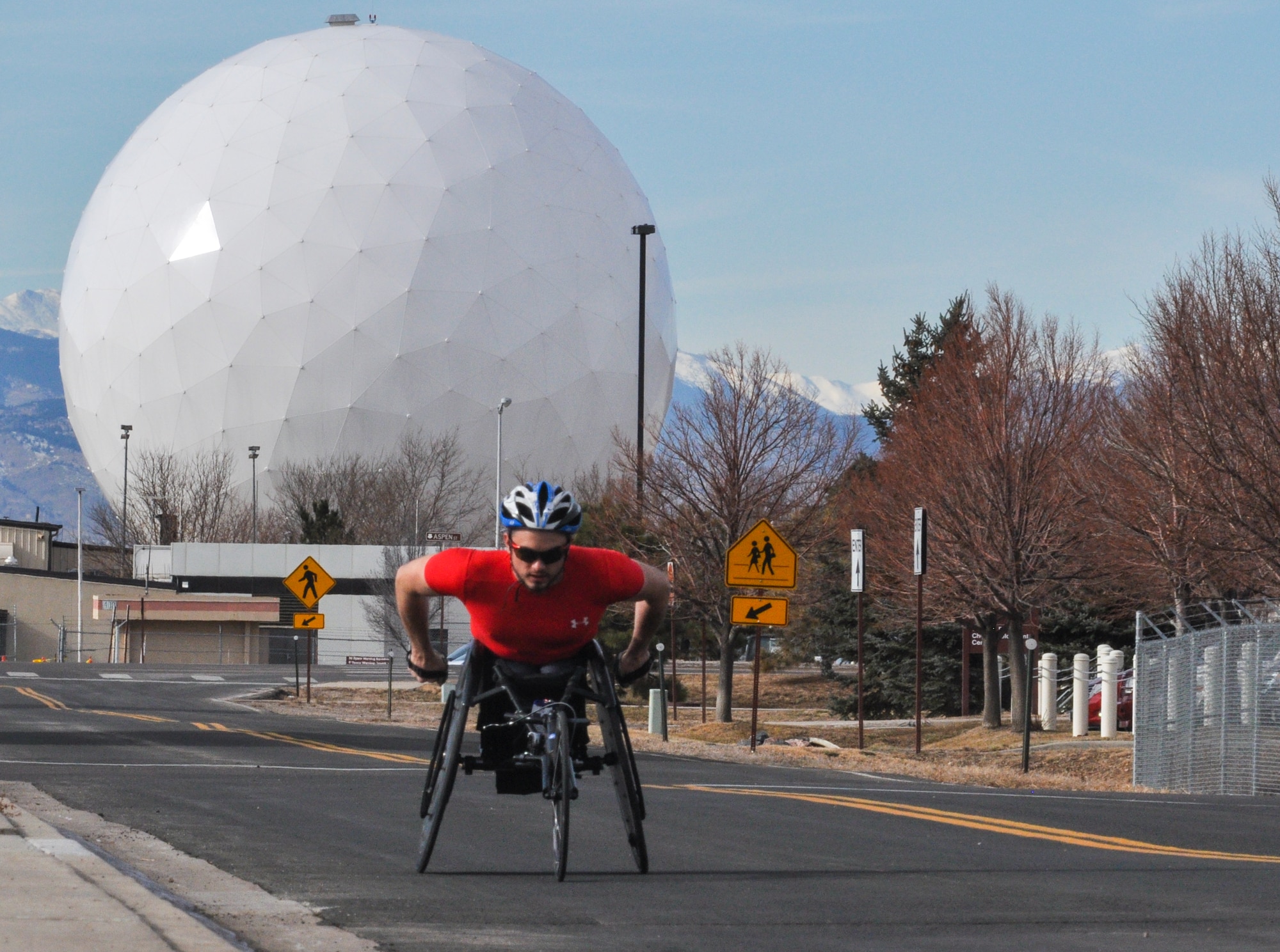 Tyler Byers, Team Buckley civilian Airman and two-time Paralympic Games competitor, keeps his body in top-notch racing shape by training on the base roads Dec. 18, 2014, at Buckley Air Force Base, Colo. Byers competed in the 2004 Paralympic Games in Athens and the 2008 Paralympic Games in Beijing. (U.S. Air Force photo by Staff Sgt. Nicholas Rau/Released) 