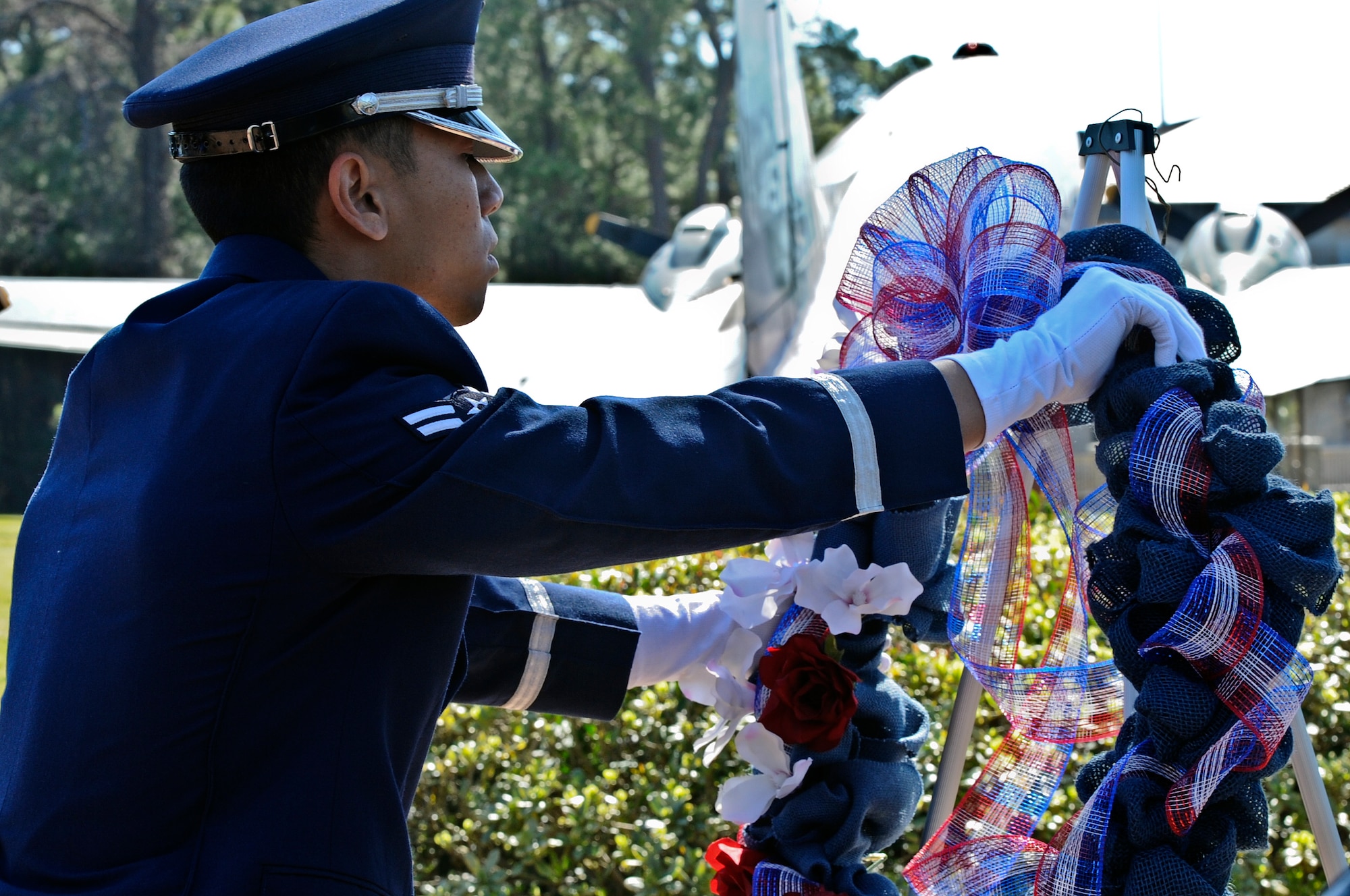 A honor guardsman lays a wreath during the memorial ceremony for Jockey-14 at the air park on Hurlburt Field, Fla., March 14, 2014. Today marked the 20th anniversary of when the aircraft experienced an in-flight explosion, which killed eight of the 14 aircrew members who were supporting Operation Continue Hope II in Somalia. (U.S. Air Force photo/Senior Airman Michelle Patten)

