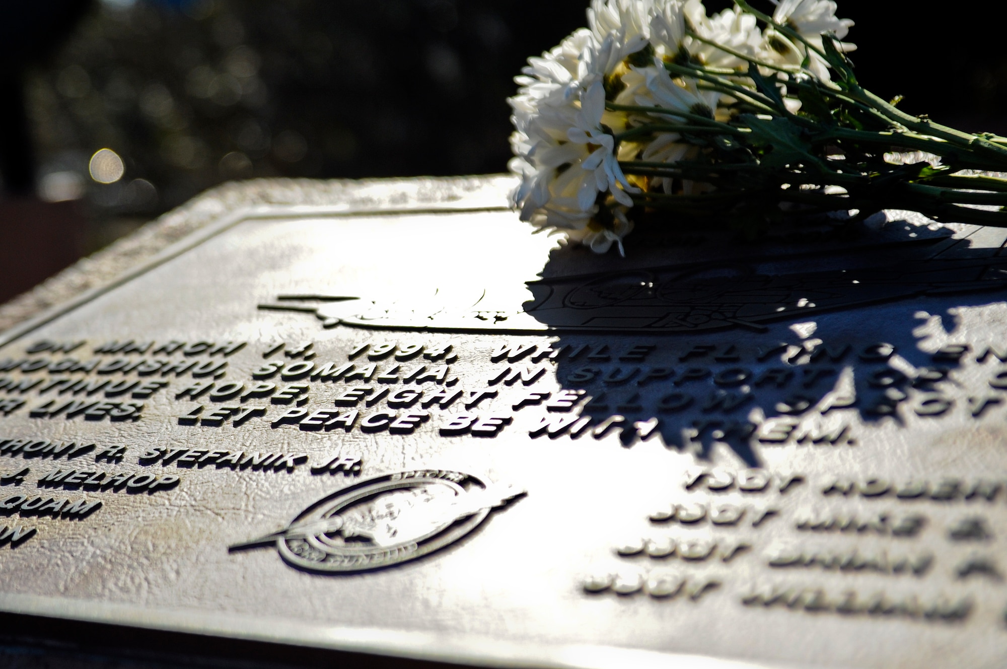 Flowers rest at a memorial commemorating the crew of Jockey-14 at the air park on Hurlburt Field, Fla., March 14, 2014. Today marked the 20th anniversary of when the aircraft experienced an in-flight explosion, which killed eight of the 14 aircrew members who were supporting Operation Continue Hope II in Somalia. (U.S. Air Force photo/Senior Airman Michelle Patten)

