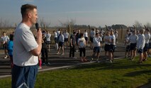U.S. Air Force Col. David Cox, 100th Air Refueling Wing vice commander, speaks to wing run participants March 14, 2014, on RAF Mildenhall, England. The monthly 5 km run encourages morale and camaraderie throughout the base. The run, designed to provide exercise and healthy competition, is open to all military ID holders. (U.S. Air Force photo by Senior Airman Micaiah Anthony/Released)