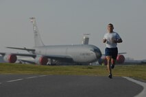 U.S. Air Force Senior Master Sgt. Cesar Flores, 351st Air Refueling Wing superintendent from Fort Worth, Texas, runs during the wing 5km run March 14, 2014, on RAF Mildenhall, England. Flores took 1st place in the event with a run time of 17 minutes, 30 seconds. Each month, Team Mildenhall members gather for exercise and friendly competition. Starting at the Hardstand Fitness Center, participants run along the designated base perimeter route. (U.S. Air Force photo by Senior Airman Micaiah Anthony/Released)