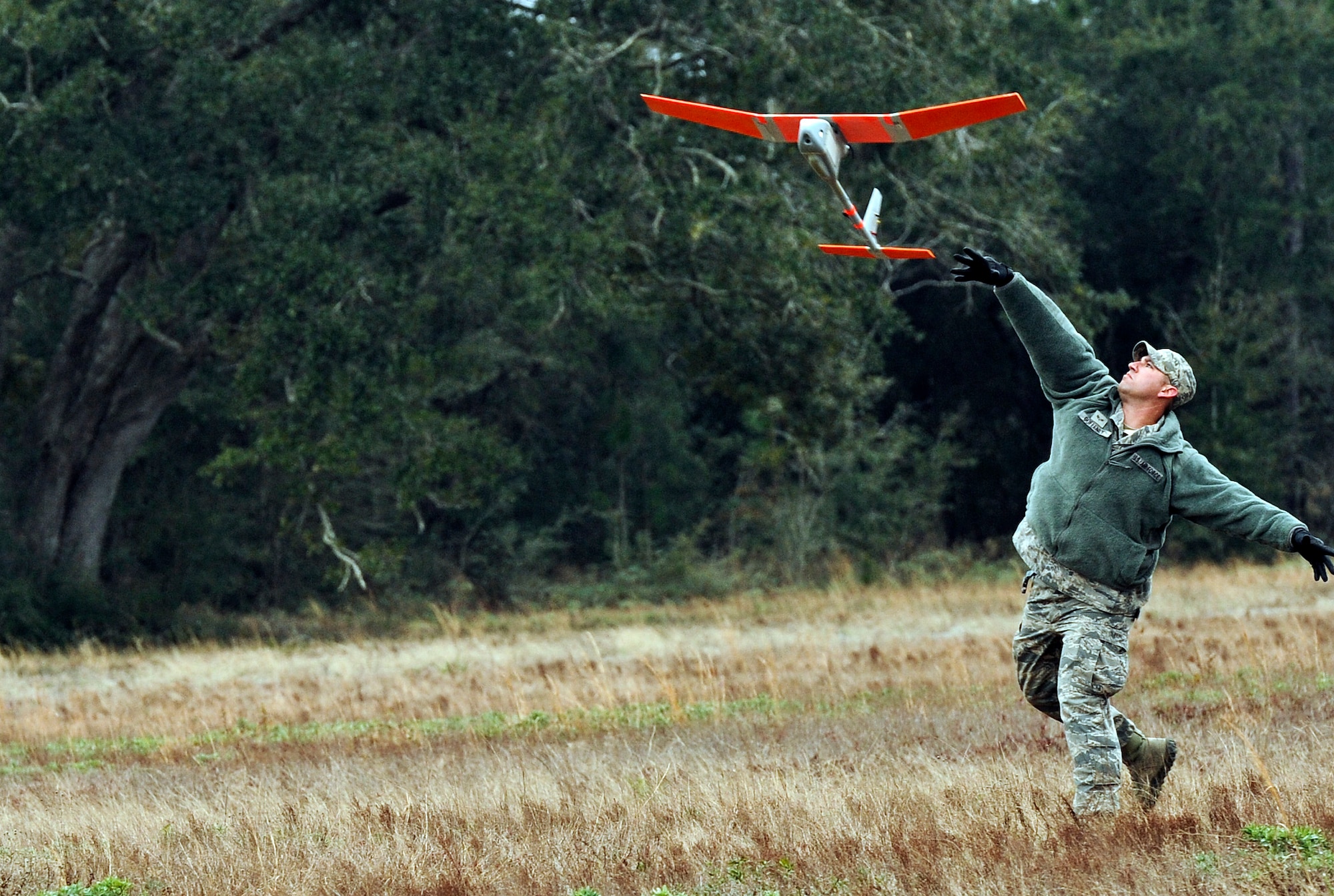 Senior Airman Andrew Goffeney, 1st Special Operations Security Forces Squadron combat arms journeyman, launches a RQ-11B Raven at Choctaw Field, Fla., March 4, 2014. Goffeney practiced launching the small unmanned aerial system, which requires a specific technique for takeoff. (U.S. Air Force photo/Senior Airman Michelle Patten)