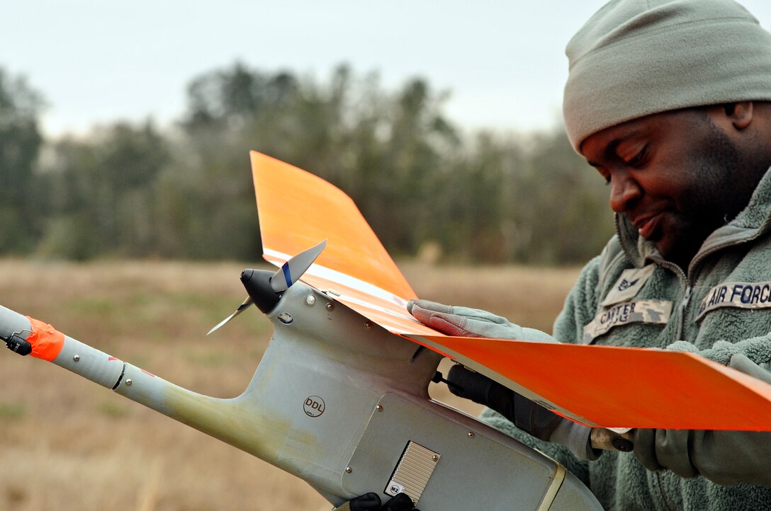 Staff Sgt. Jonathan Carter, 1st Special Operations Security Forces Squadron desk sergeant, conducts pre-flight checks of a RQ-11B Raven at Choctaw Field, Fla., March 4, 2014. Carter performed pre-flight checks to ensure the small unmanned aerial system would operate safely and correctly. (U.S. Air Force photo/Senior Airman Michelle Patten)

