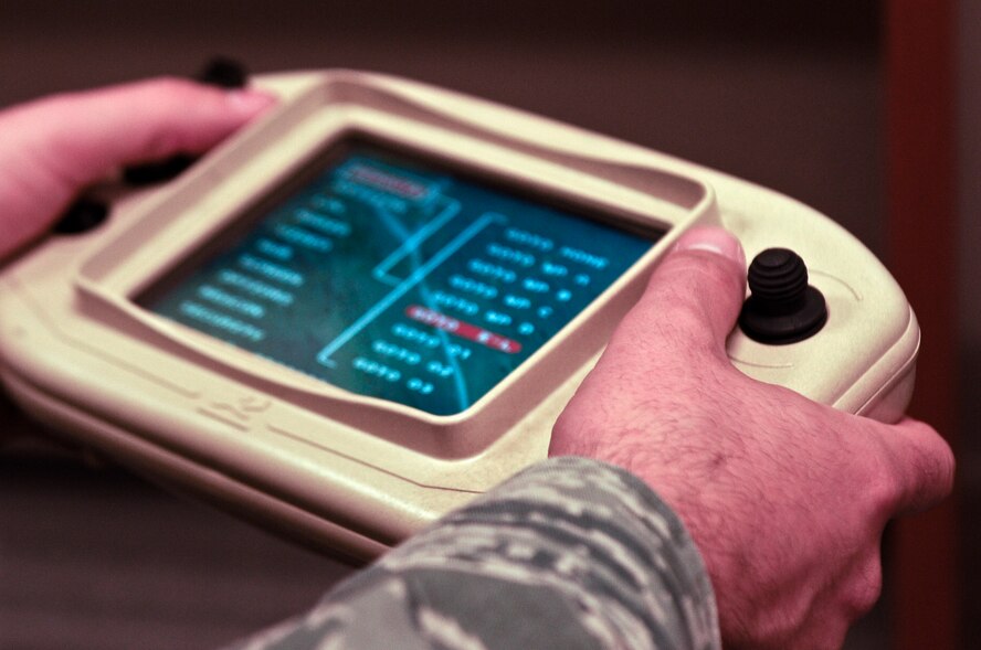 Senior Airman Andrew Goffeney, 1st Special Operations Security Forces Squadron combat arms journeyman, practices using a small unmanned aerial system simulator in a unit training room at Hurlburt Field, Fla., March 4, 2014. The controller, which is used for simulator training and live flights, resembles video game controllers. (U.S. Air Force photo/Senior Airman Michelle Patten) 