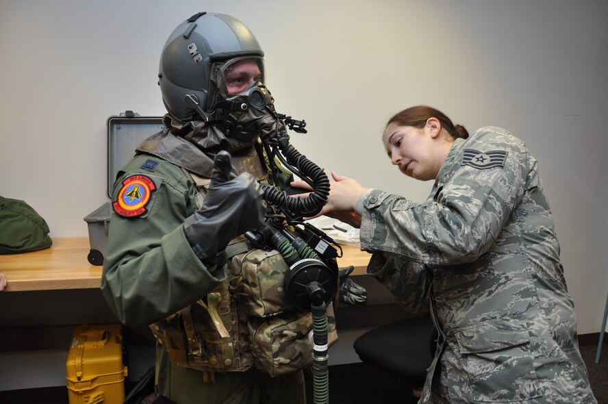 Staff Sgt. Iva Marshall, 60th Operations Support Squadron Aircrew Flight Equipment technician, adjusts an integrated aircrew body armor system on Capt. Jamie Leenman, 21st Airlift Squadron pilot, as he gives the thumbs up signal that all equipment fits well. Aircrew and AFE technicians went over IABA concepts and variations in a classroom training environment prior to testing aboard aircraft March 3 to 7. (U.S. Air Force photo/Staff Sgt. Christopher Carranza)