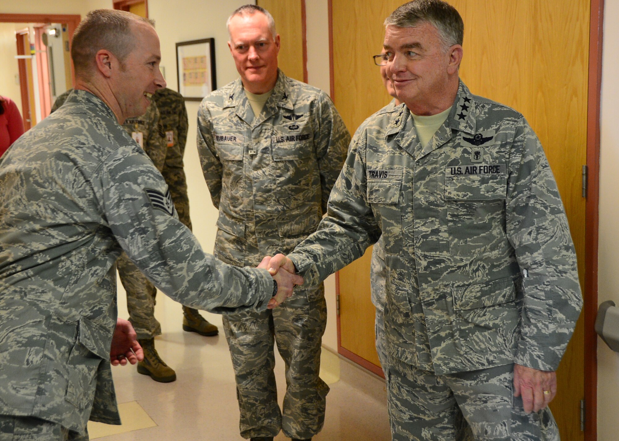Lt. Gen. Thomas Travis, Surgeon General of the Air Force, visits with Airmen assigned to the 48th Medical Group on Royal Air Force Lakenheath, England, March 14, 2014. Travis visited with various medical departments and had the opportunity to speak to the Airmen about their everyday mission requirements. (U.S. Air Force photo by Airman 1st Class Erin O’Shea)